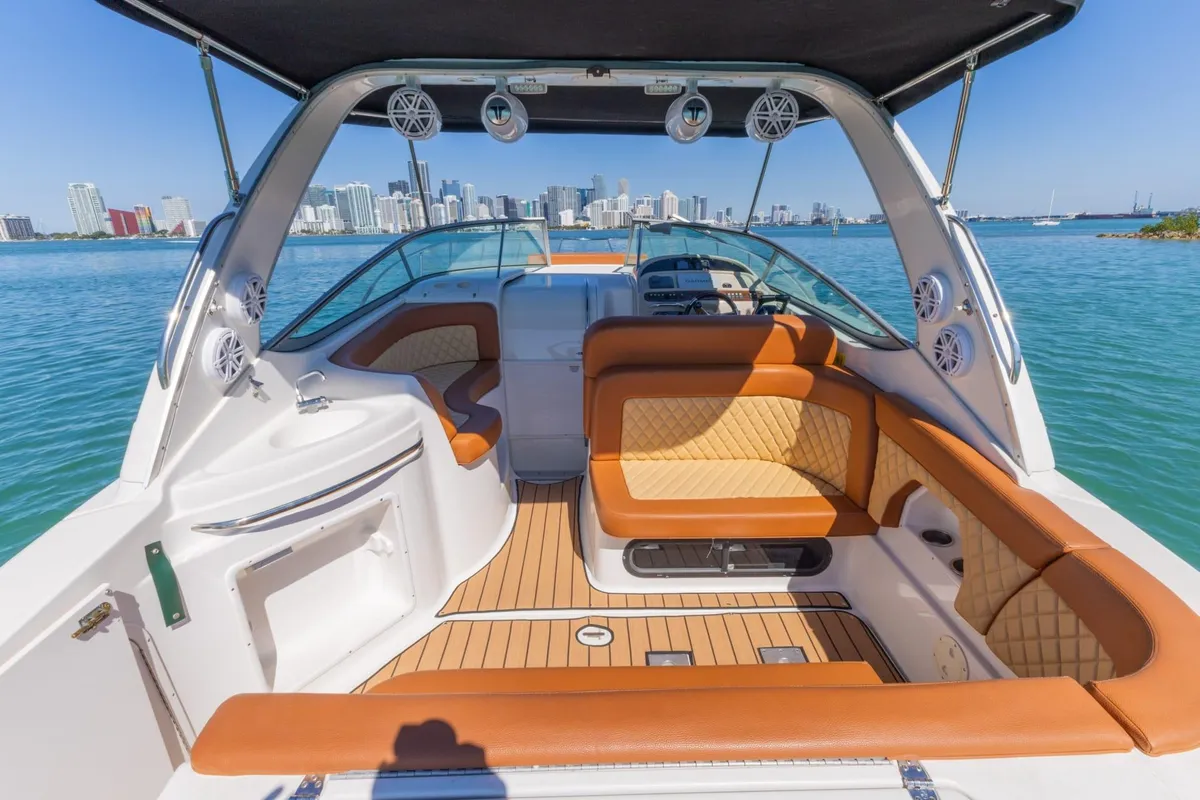 Captain narrating a scenic private boat tour in Miami as the boat passes Star Island waterfront homes
